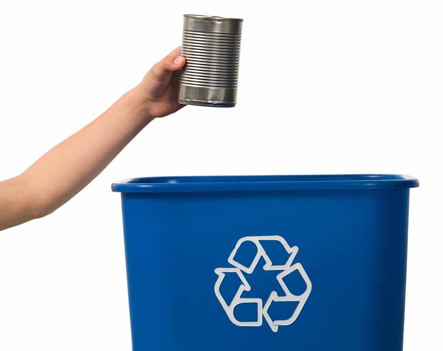 A boy recycling an Aluminium tin ready to be sorted by the HRL Recycling Team.