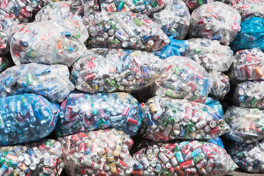 Carrier bags loaded with Aluminium cans and tins ready to be sorted by the HRL Recycling Team.